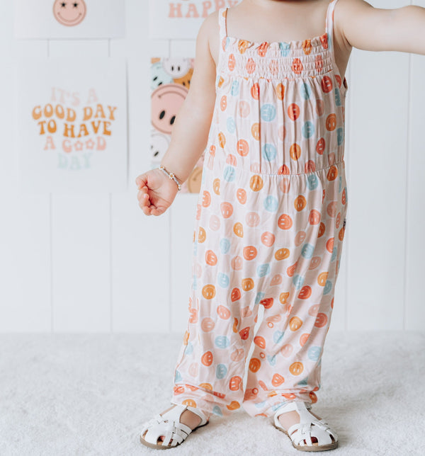 Dream Big Little Co HAPPY DAYZZZ SMOCKED JUMPSUIT